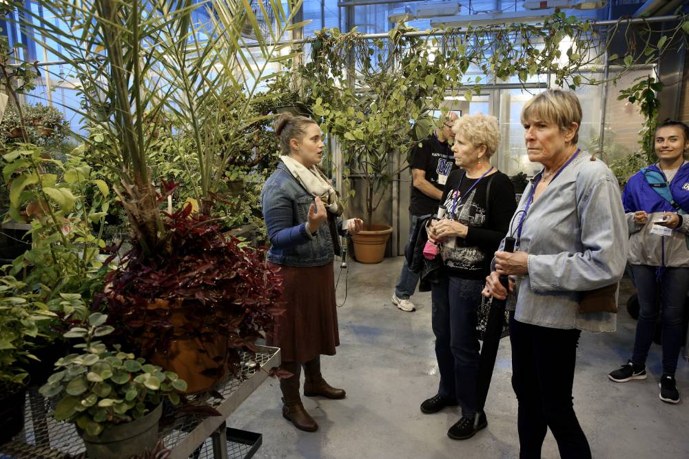Class of '68 takes a tour through the greenhouse at Kindschi Hall.
